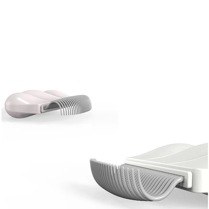 Paw Soft deshedding brush grooming tool for cats and dogs on a white surface.