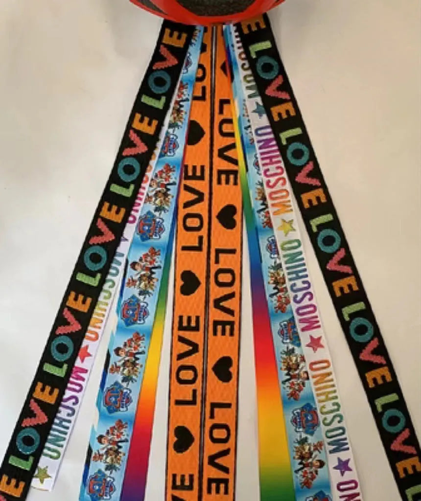 Colourful decorative ribbon streamers attached to a children safety helmet for skating or skiing