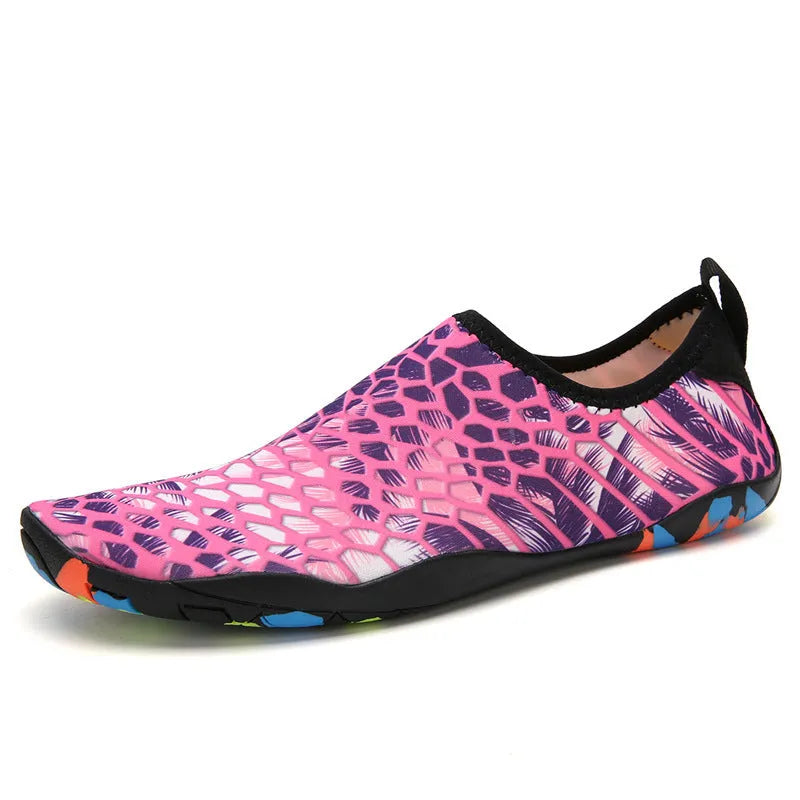 Blue Lycra beach wading shoes with EVA midsole on a sandy beach