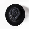 Handmade wool felt skull hat with a conical crown on a model, shown in the skull hat colour variant.