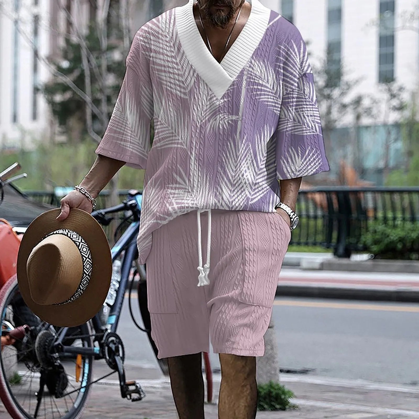 Men's grey printed knitted short-sleeved top and matching shorts on a hanger.