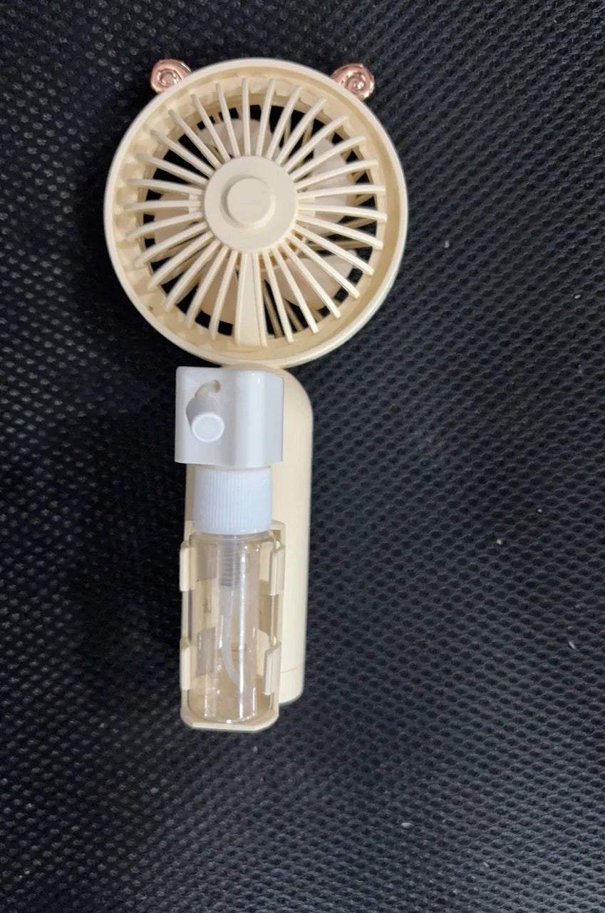 Small plastic nozzle fan in apricot colour with USB charging port