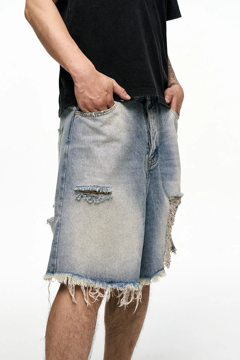 Light blue washed men's denim shorts with a baggy wide leg fit on a mid waist.