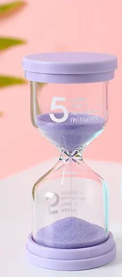 Handmade glass sand timer with blue sand, showing modern minimalist hourglass design.