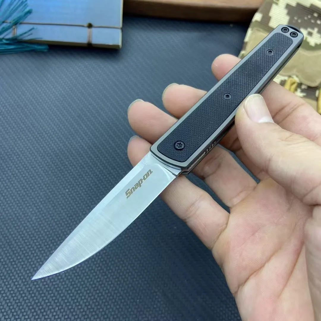 Folding fruit knife with stainless steel blade in black, brown, or red handle colours