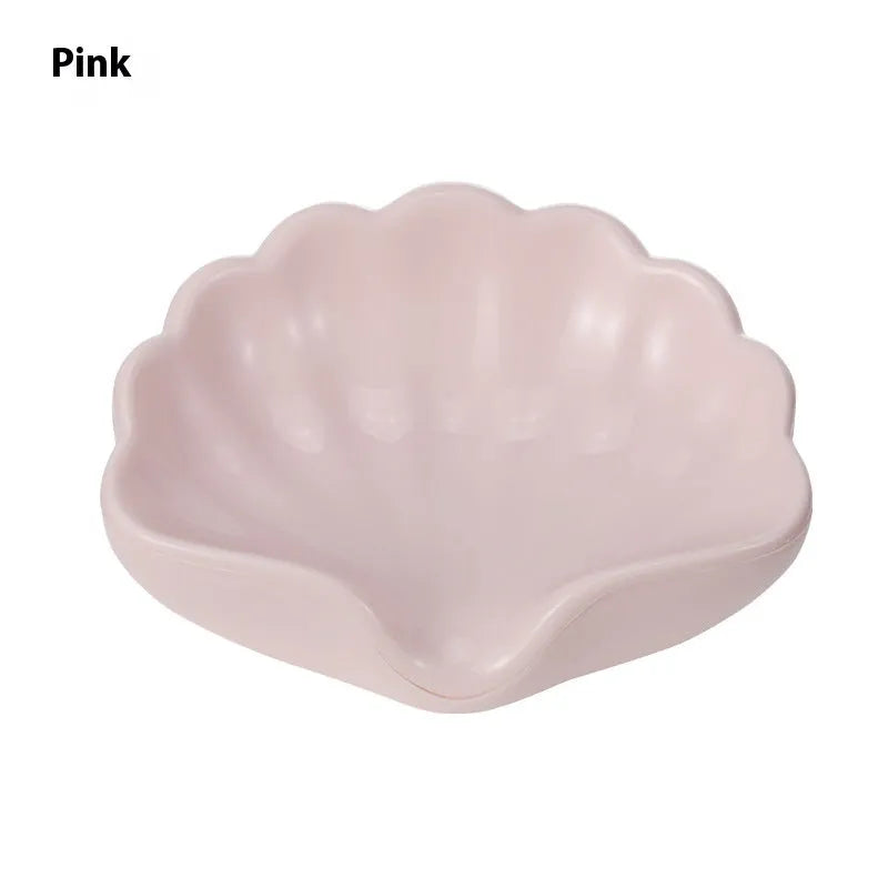 Plastic shell-shaped soap dish in pearl white or pink colour for bathroom organisation