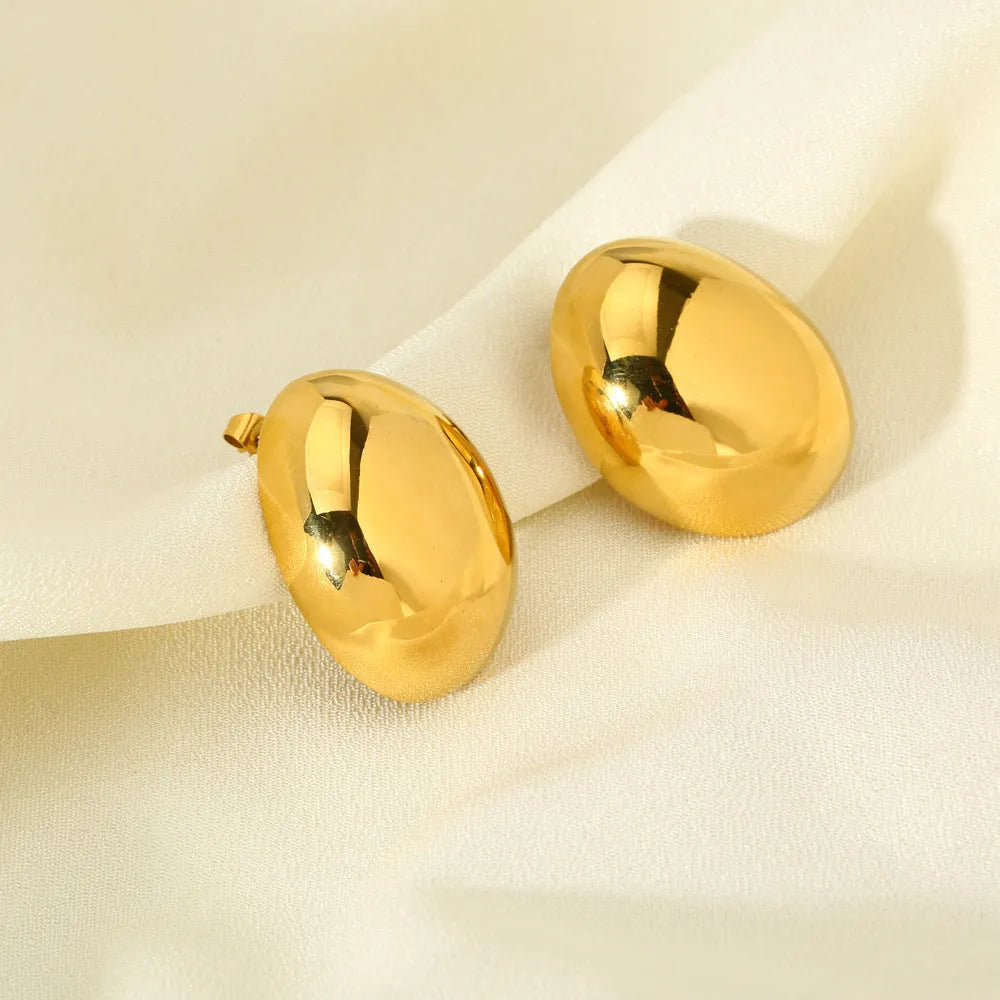 Geometric women's earrings with a gold glazed finish and simple line designs on a white background.