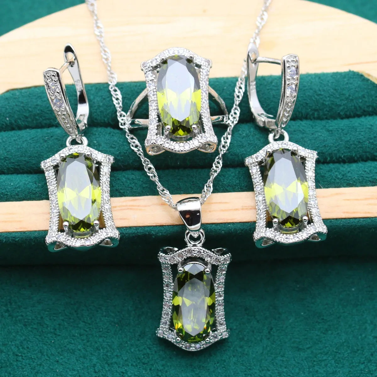 Olive and yellow anti-allergy alloy zircon jewellery set showing necklace, earrings, ring, and bracelet on a display.