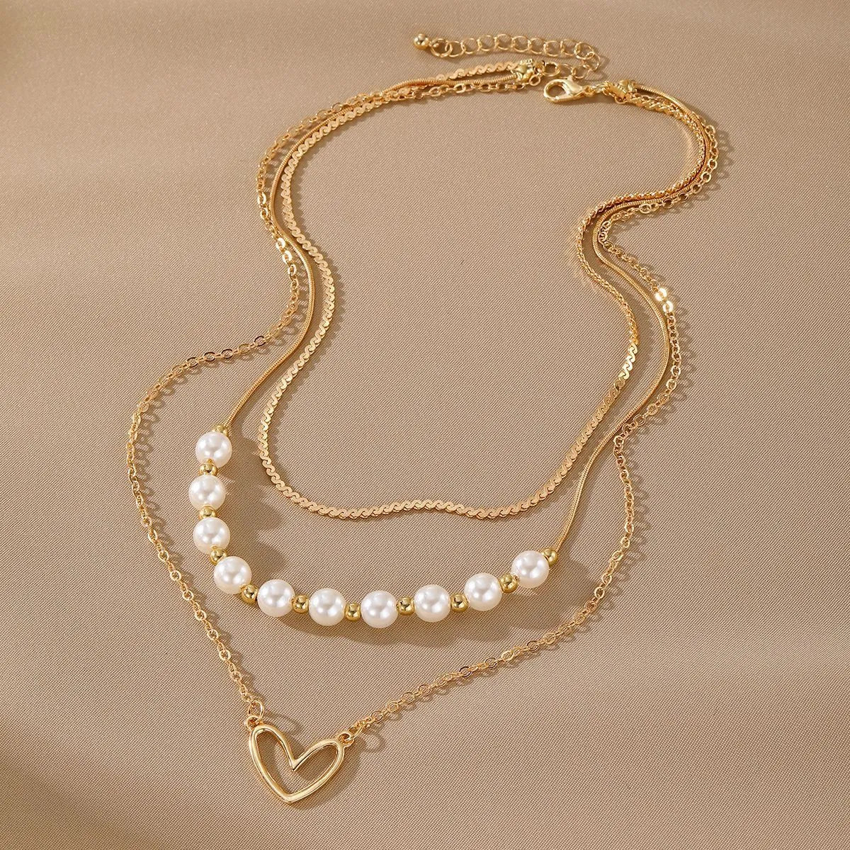 Vintage gold-tone heart pendant necklace with pearl chain and adjustable length