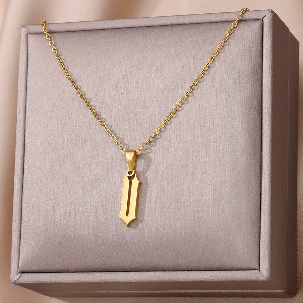 Gold stainless steel ancient English letter pendant necklace with O-ring chain on white background