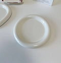 White ceramic plate with doodle design showing bear pattern, suitable for microwave use