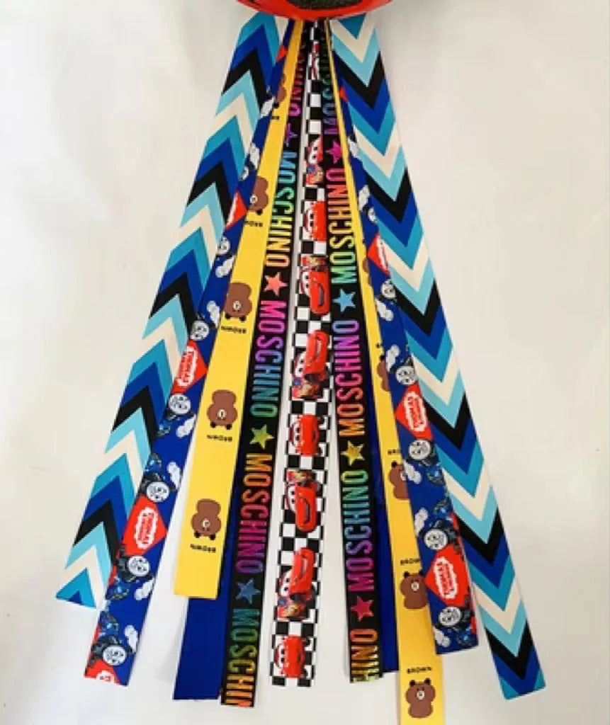 Colourful decorative ribbon streamers attached to a children safety helmet for skating or skiing