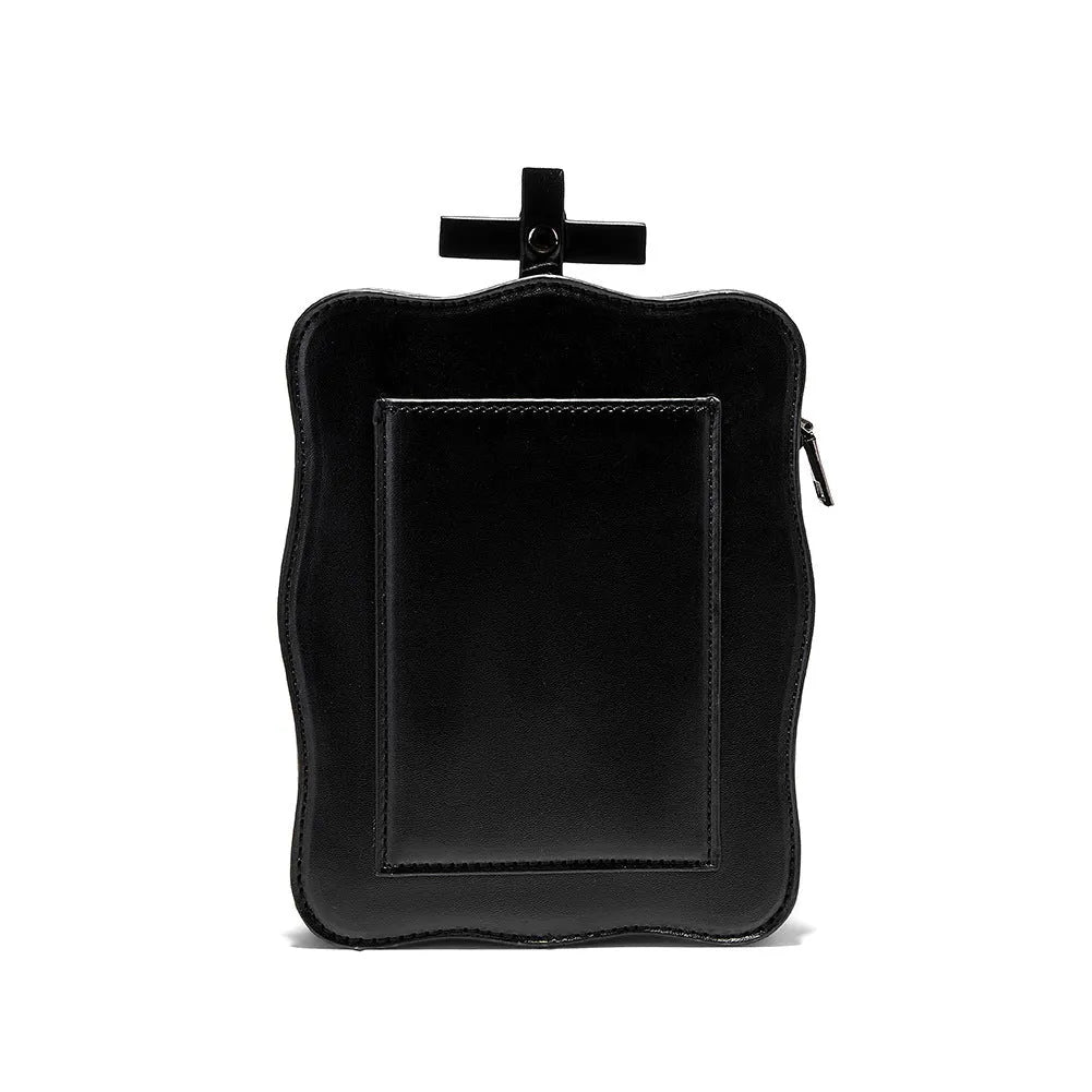 Black mini square messenger bag with embossed skull design, featuring stitching, rivets, chain details and zipper closure