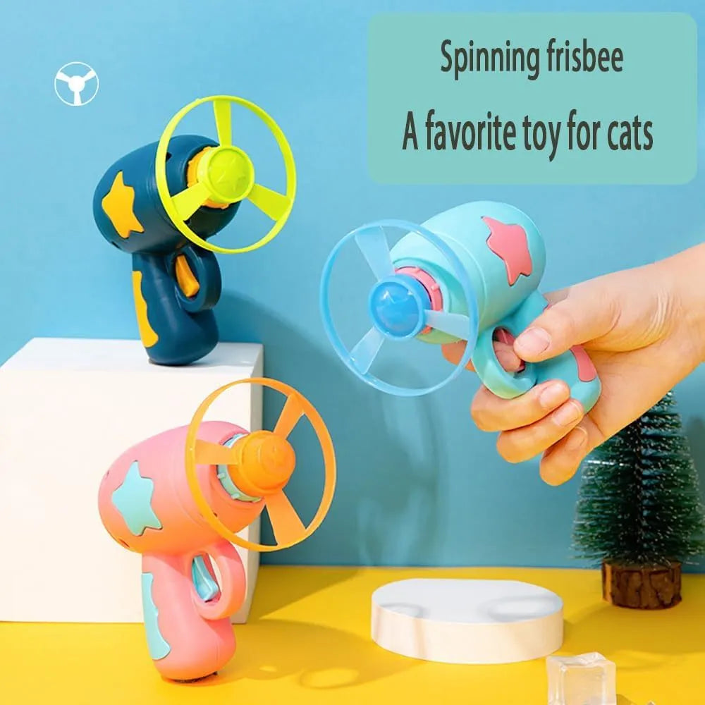 Blue interactive cat toy gun with plastic frisbee mounted ready for launching