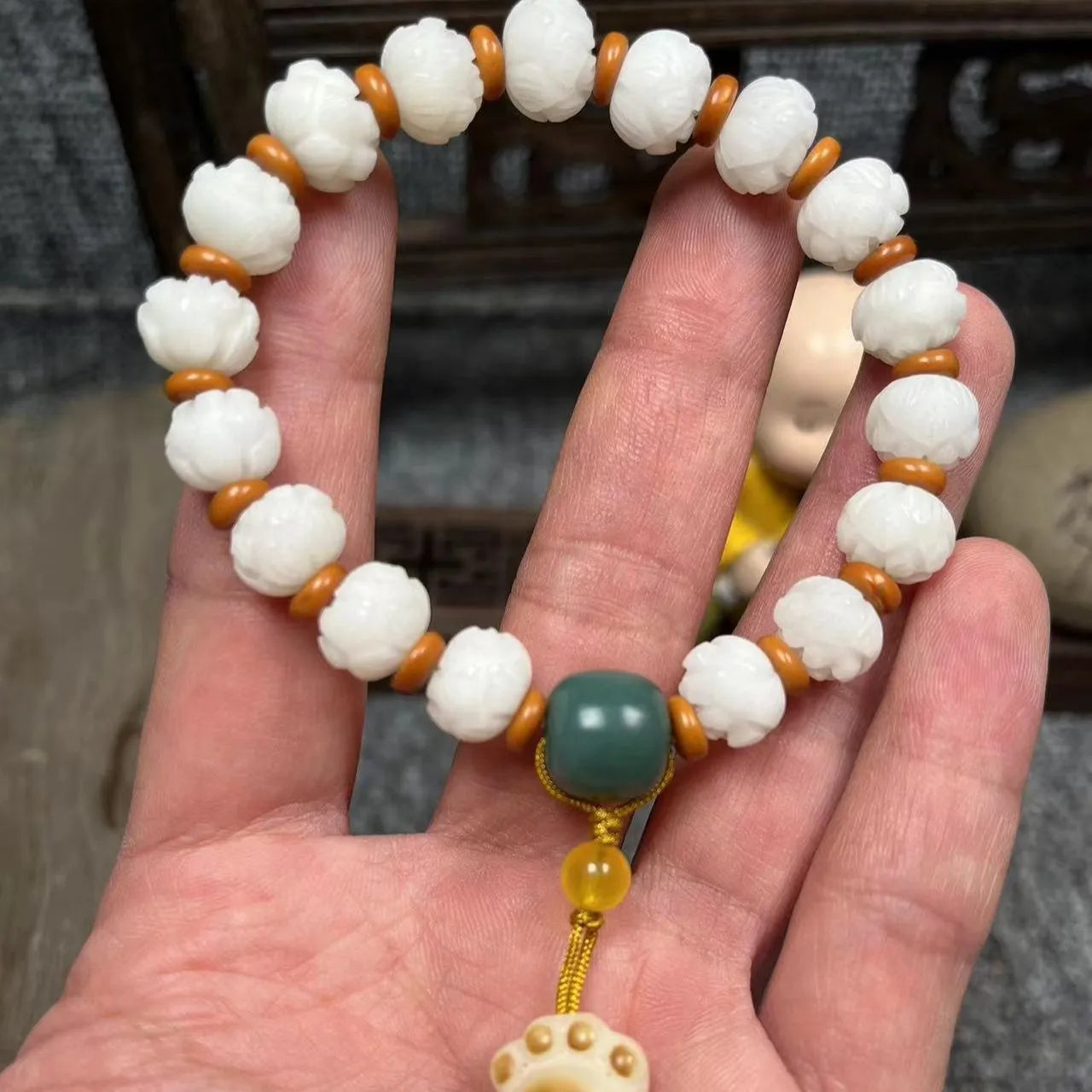 Carved pumpkin and lotus bead bracelet made from Bodhi root with white jade and aventurine details.