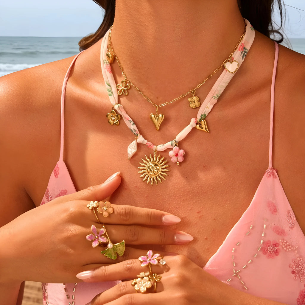 Stainless steel necklace with geometric sun pendant and gold electroplated finish on adjustable chain