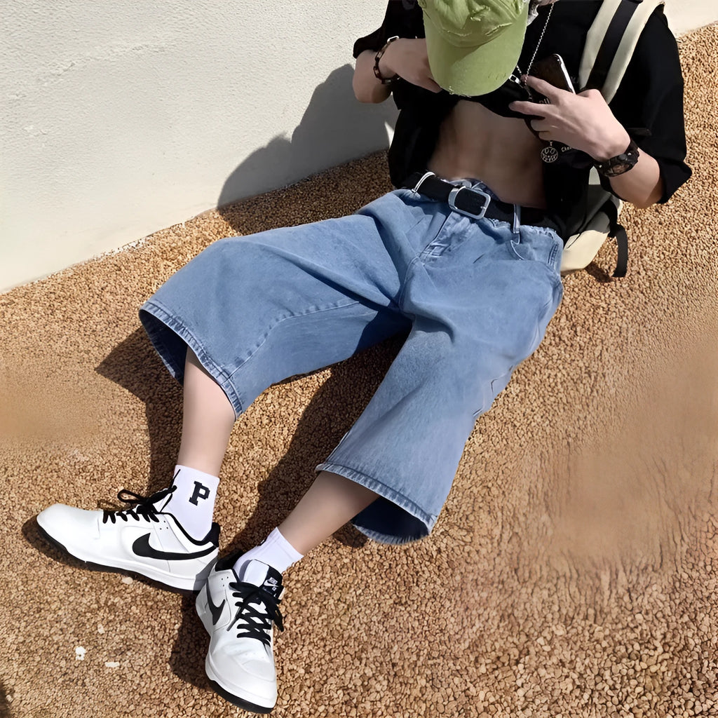 Men's washed blue denim pirate shorts with high waist and cropped straight legs on a plain background