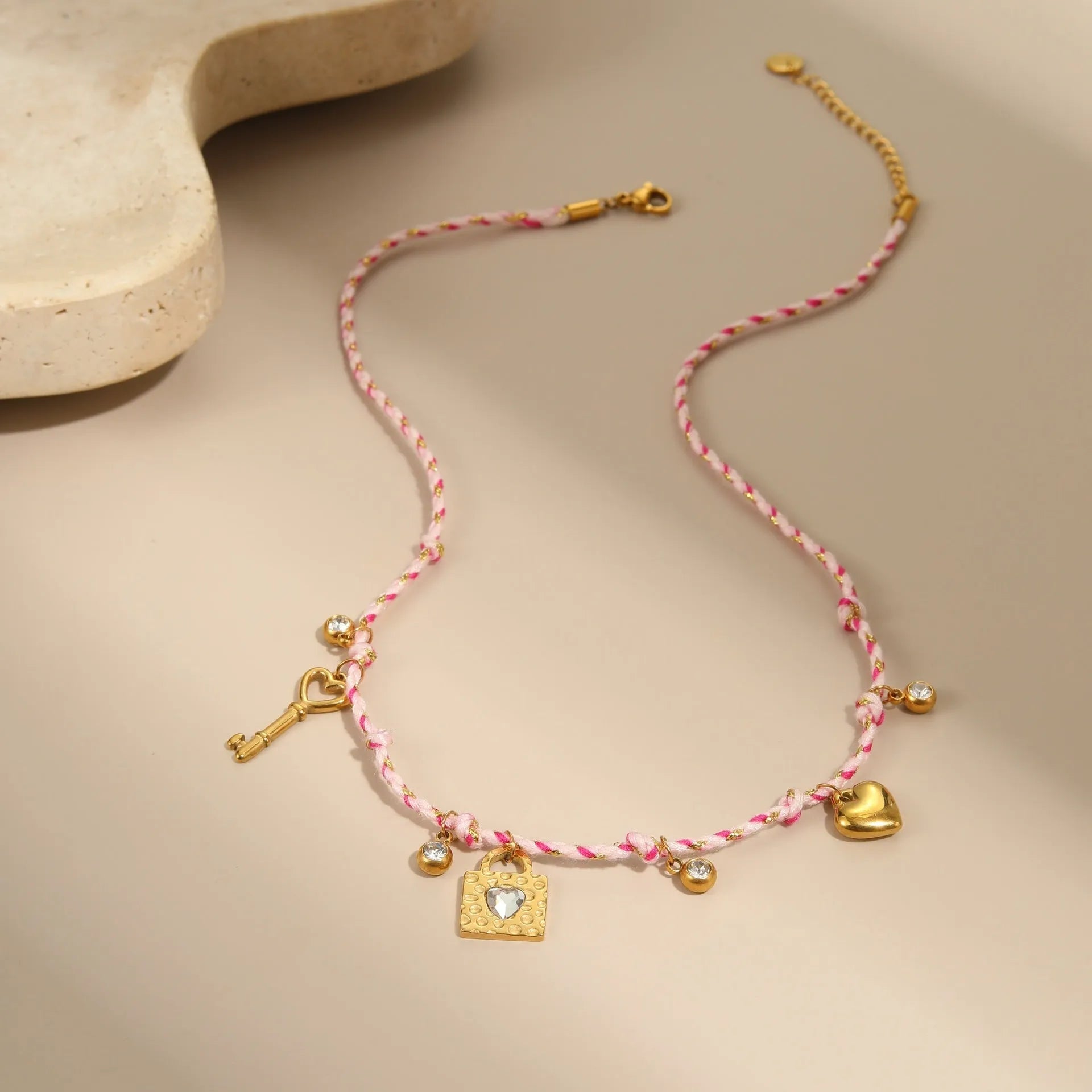 Handmade braided rope titanium steel necklace and bracelet set with 18K gold electroplated heart, star, and geometric pendants.