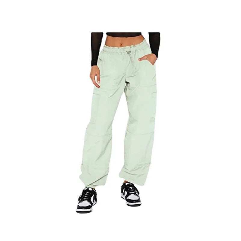 Man wearing loose grey straight-leg cargo casual pants with multiple pockets.