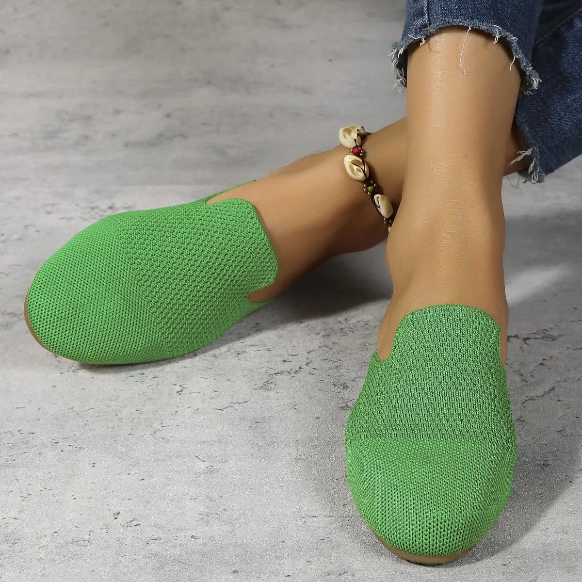 Mesh sandals in apricot, blue, and green colours showing cloth upper and flat rubber sole.