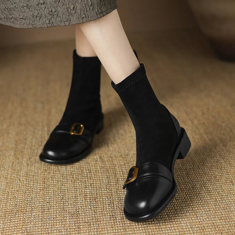 Black women's low heel martin boot with lace-up front and belt buckle stitching detail.