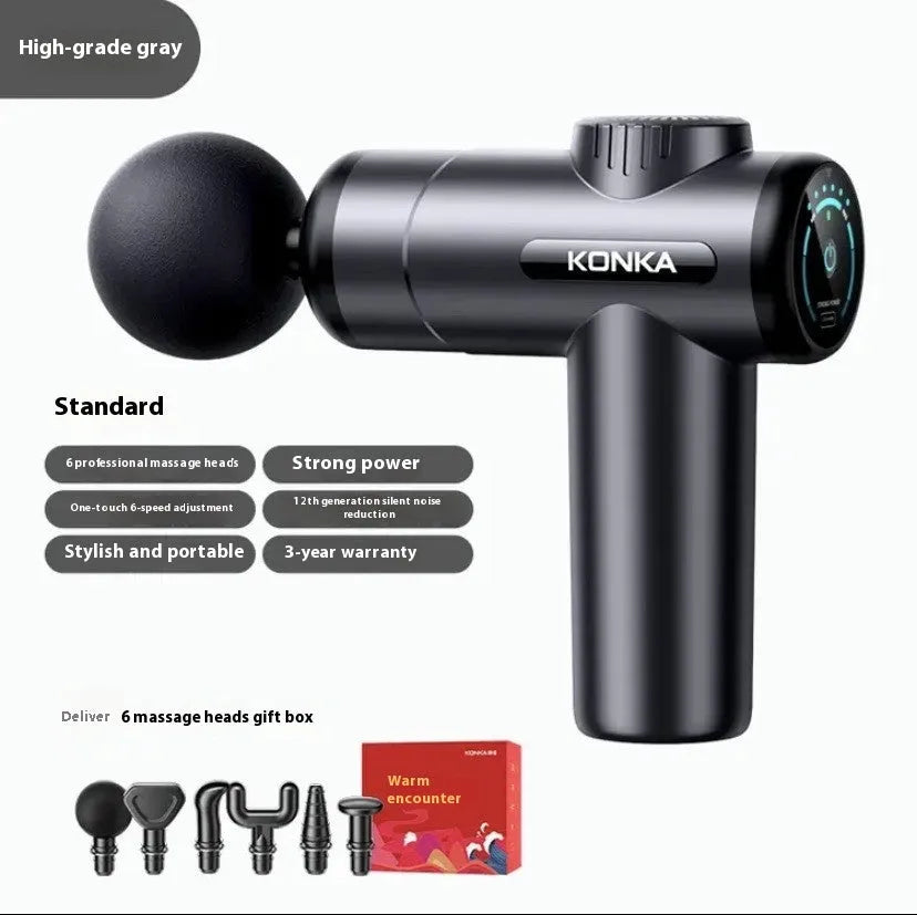 Konka professional electric mini massage gun in grey colour with multiple massage head attachments on a table.