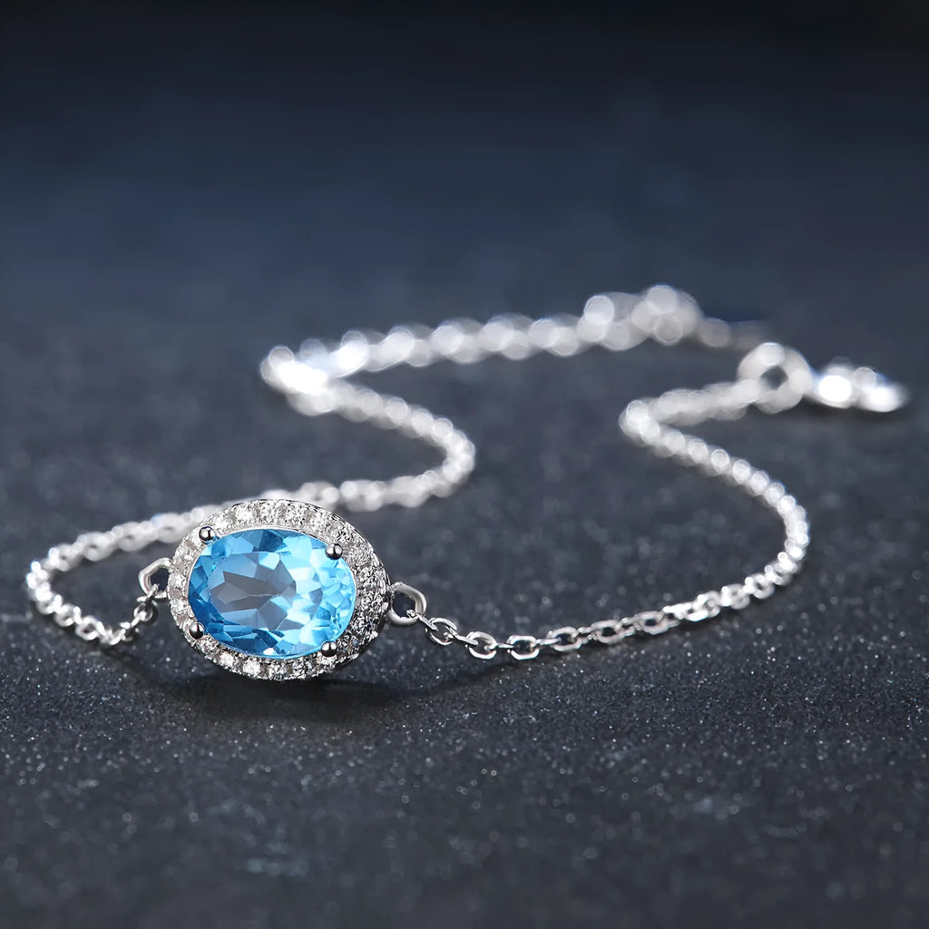 925 sterling silver jewellery set with blue topaz stones including geometric earrings, necklace, ring and pendant