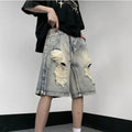 Blue retro tattered denim shorts with a wide leg and loose fit on a hanger.