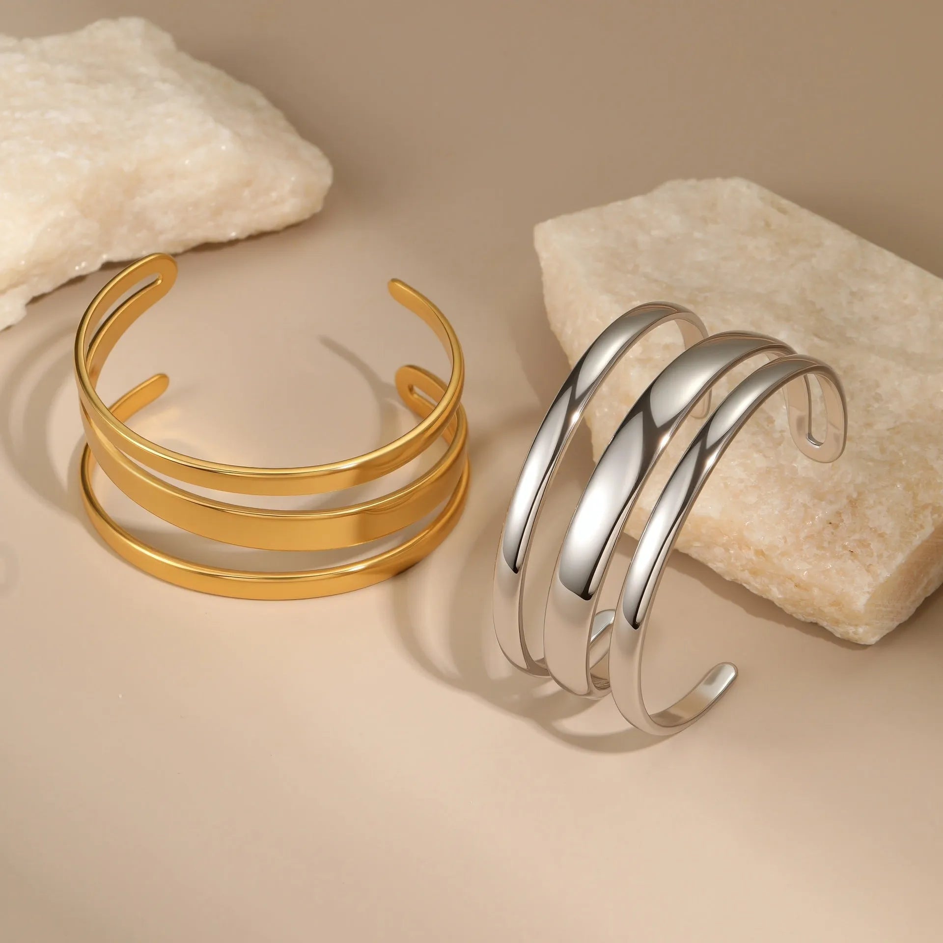 Geometric stainless steel women's bracelet with simple opening, available in gold or steel colour with linear design elements
