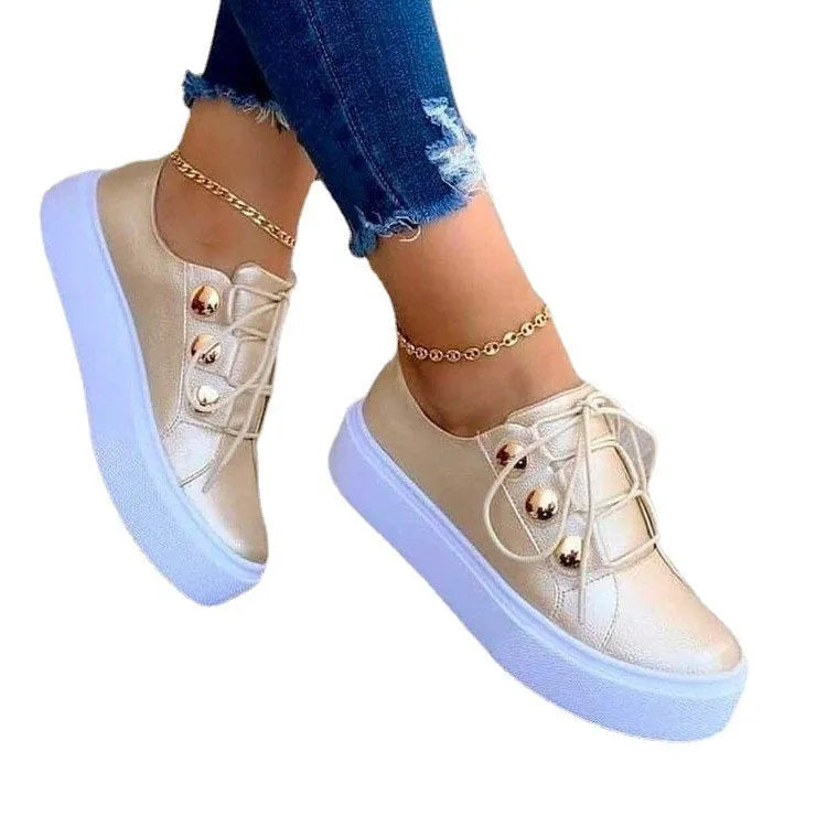 Women's white lace-up flats sneakers with metal rivet detailing and round toe design