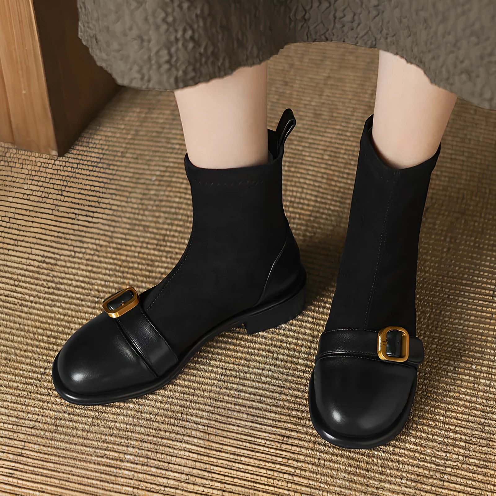 Black women's low heel martin boot with lace-up front and belt buckle stitching detail.