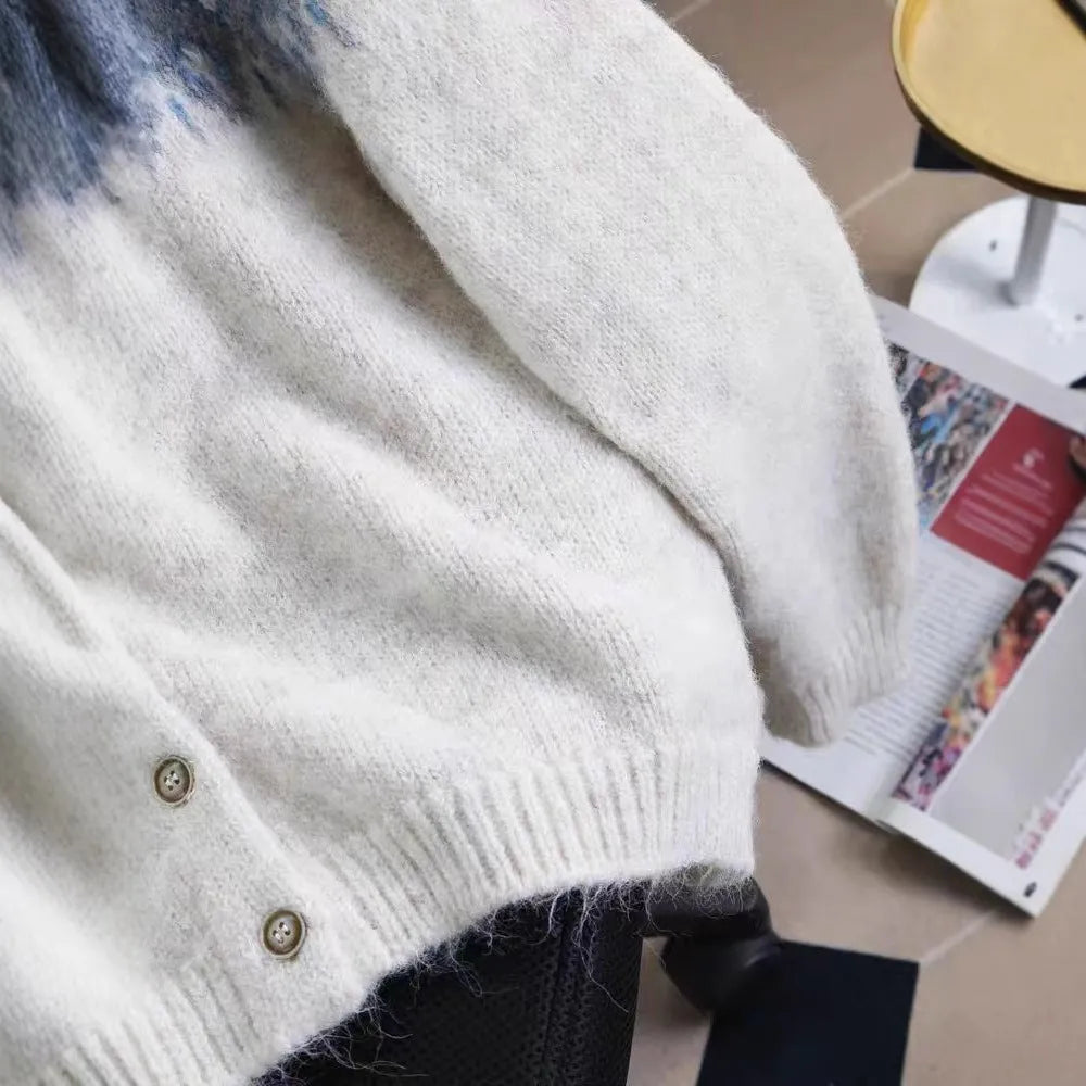 Women's beige jacquard knit sweater coat with contrast pattern, shown with long sleeves and a loose fit.
