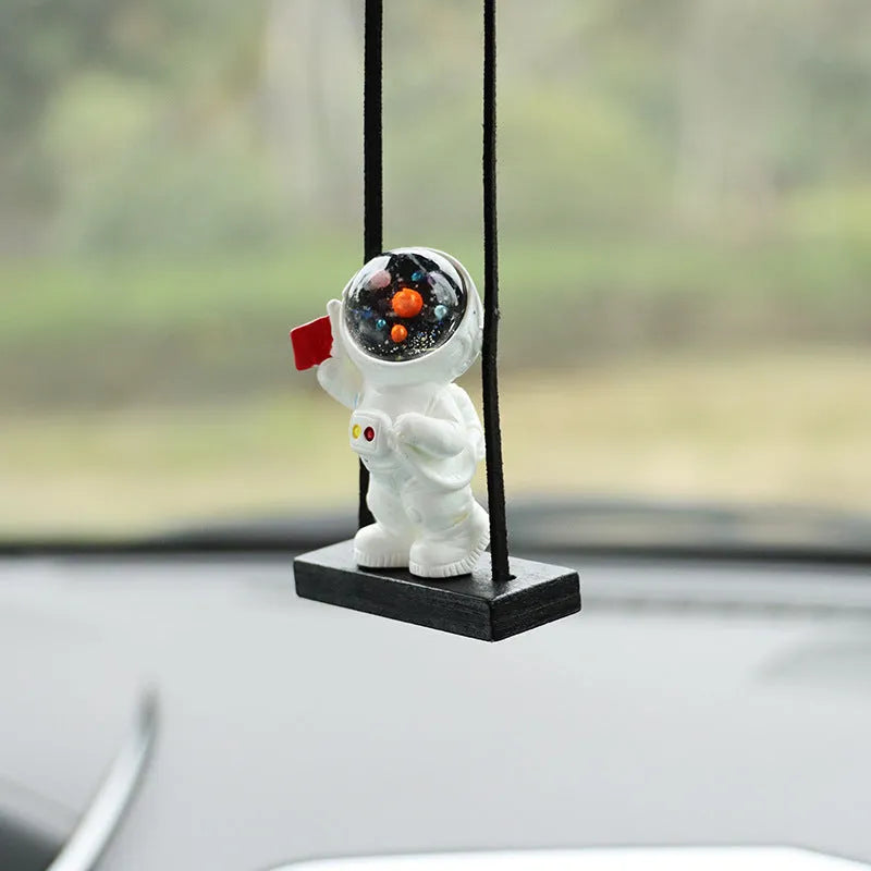 Resin astronaut car pendant in one of five cartoon colour designs