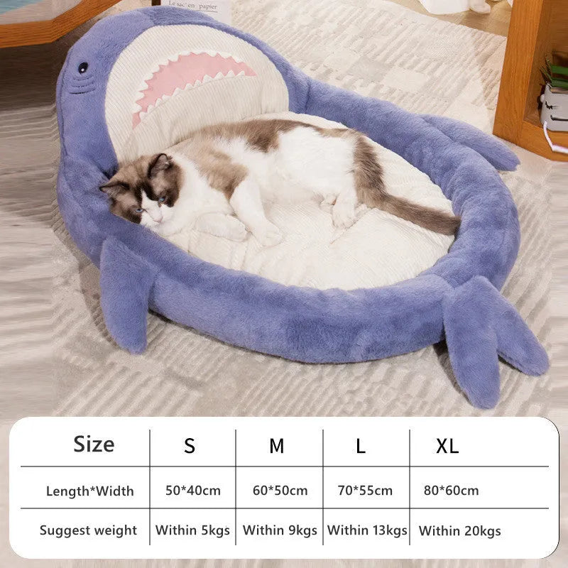 Blue shark pattern pet bed cushion on a floor, showing soft velvet material and non-slip base.