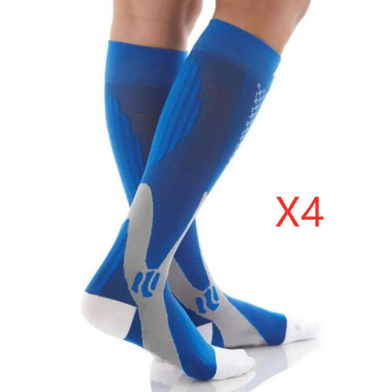 Graduated compression socks for men and women in black, shown laid flat.