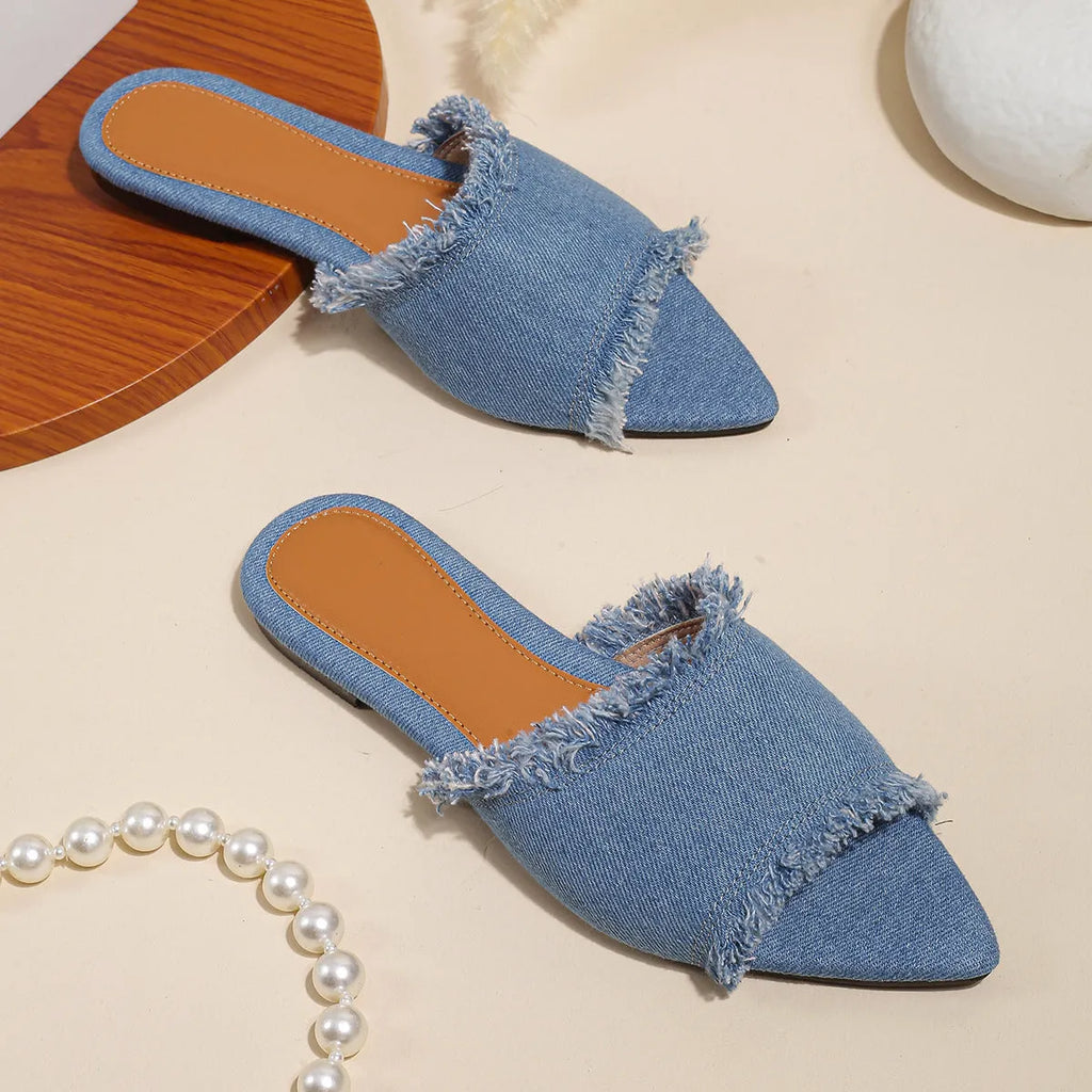 Solid colour denim women's slippers with a tassel detail, showing leather lining and PVC sole.