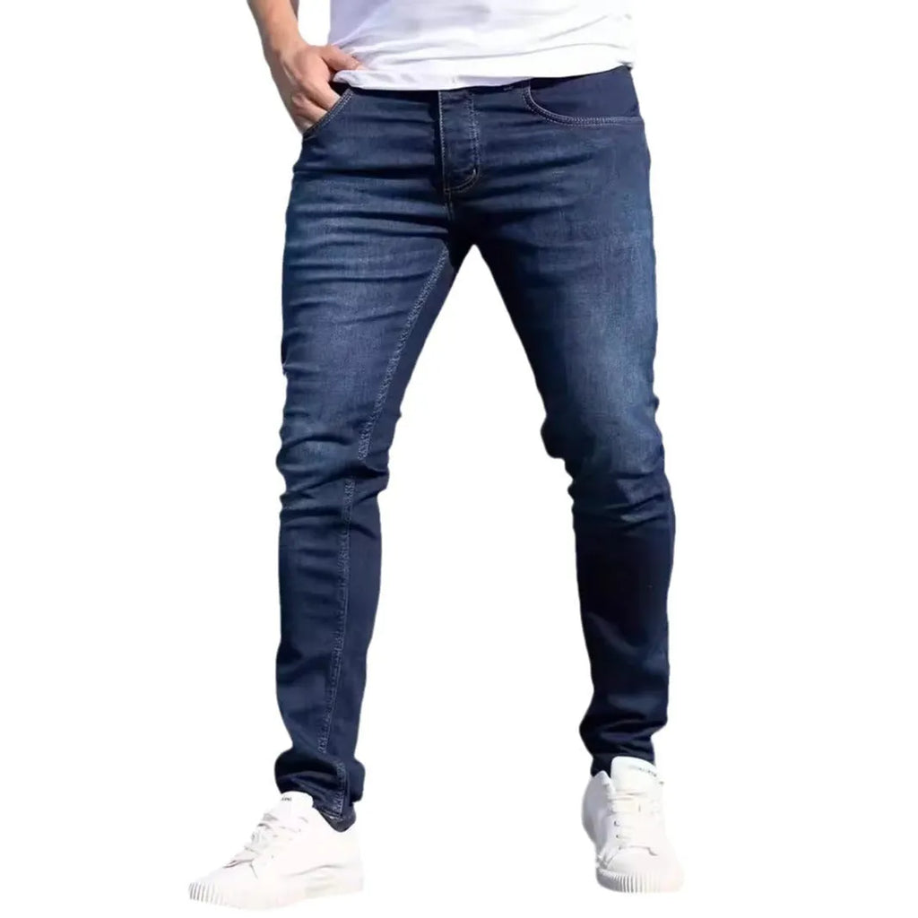 Men's dark blue slim fit casual jeans with mid waist and zipper fly opening