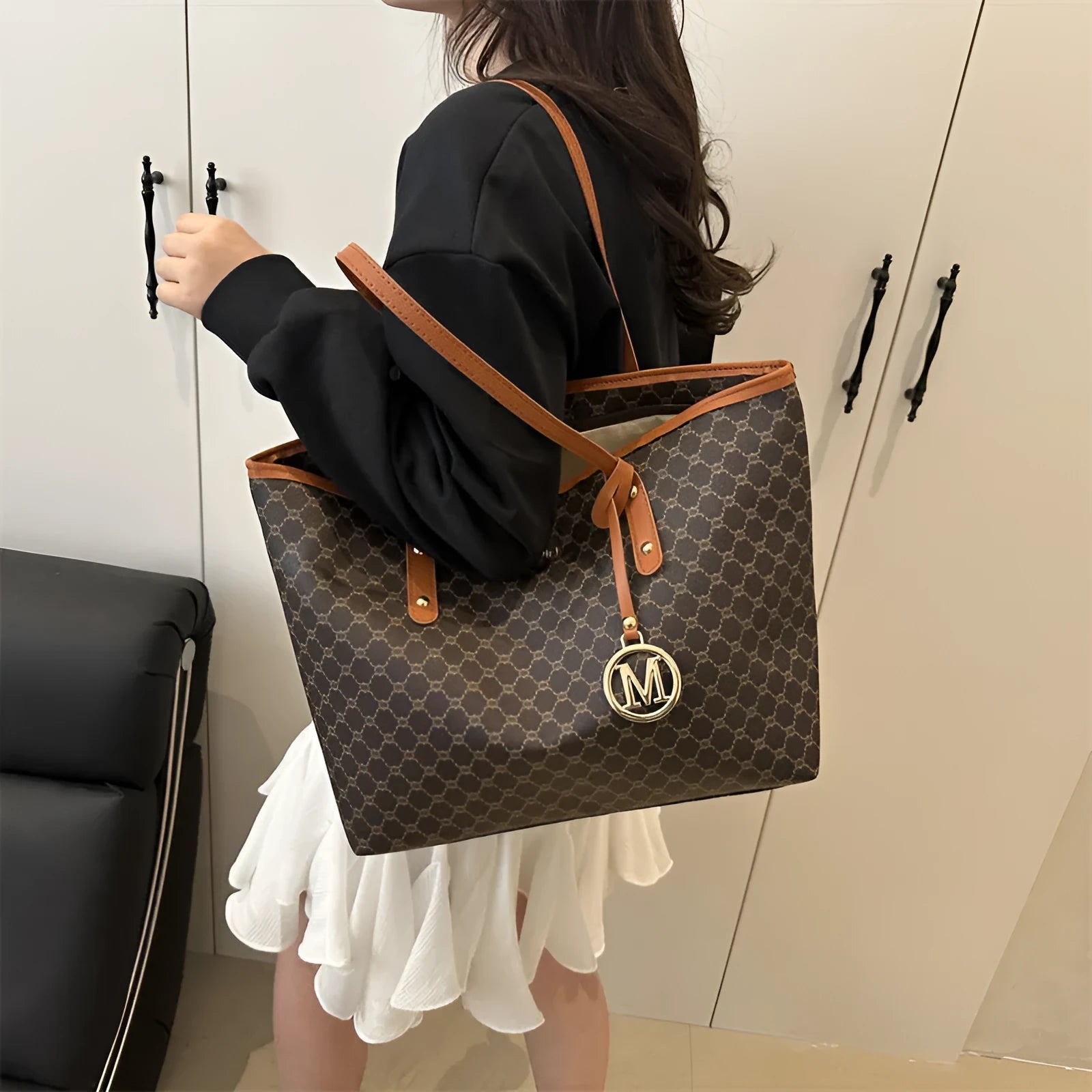 Street trend western style shoulder bag in PU material with sewn detailing, shown in black.