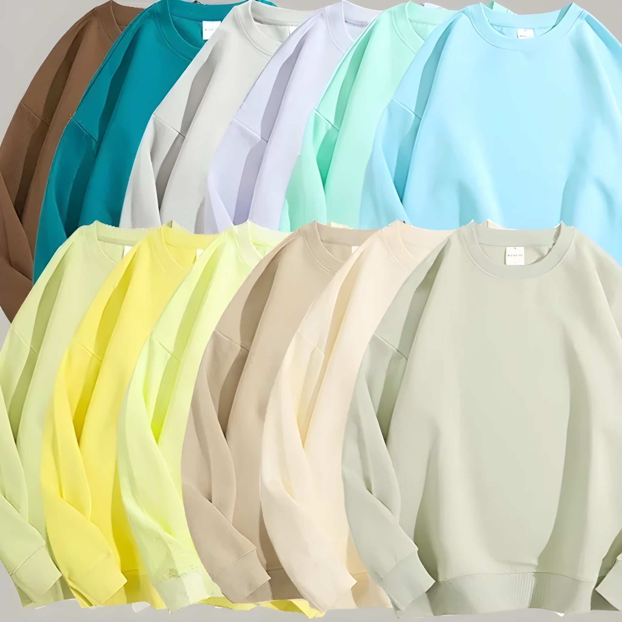 A loose-fitting, off-shoulder cotton sweater in a solid colour with long sleeves and a round neck.