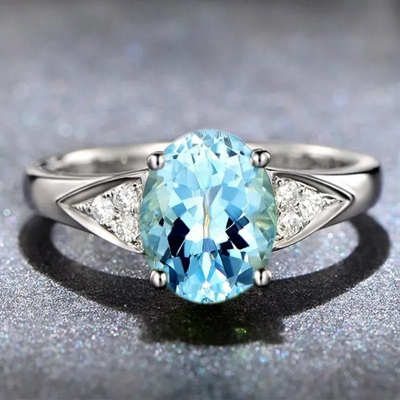 Women's blue zircon court style ring with heart, water drop, and bell pattern designs.