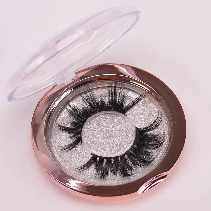 A pair of 5D volume false eyelashes made from real mink hair, with an application brush and storage case.