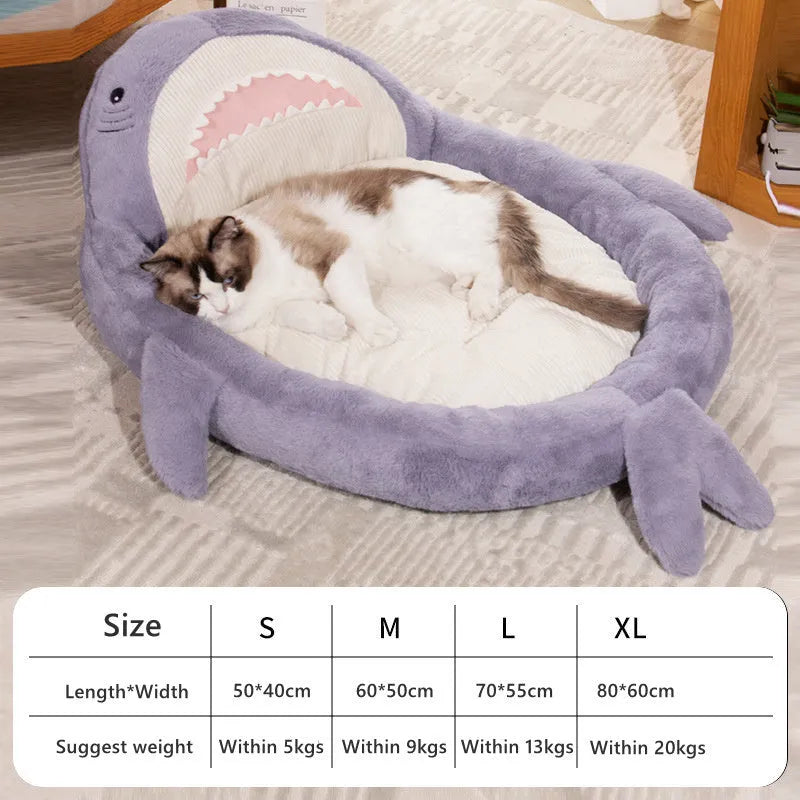 Blue shark pattern pet bed cushion on a floor, showing soft velvet material and non-slip base.