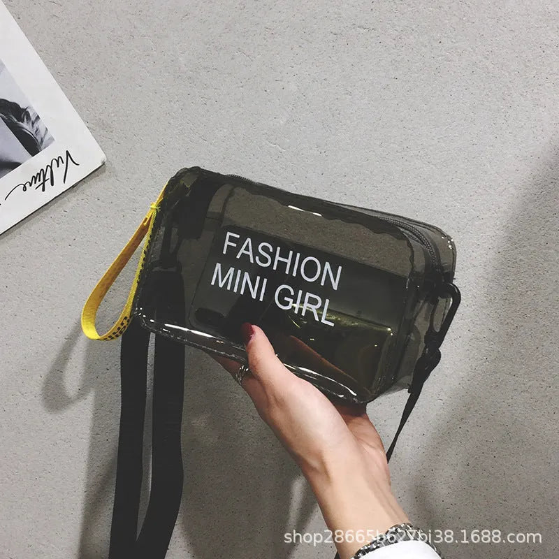 Transparent square women's shoulder bag in jelly material with a diagonal cross strap, showing internal mobile phone pocket.