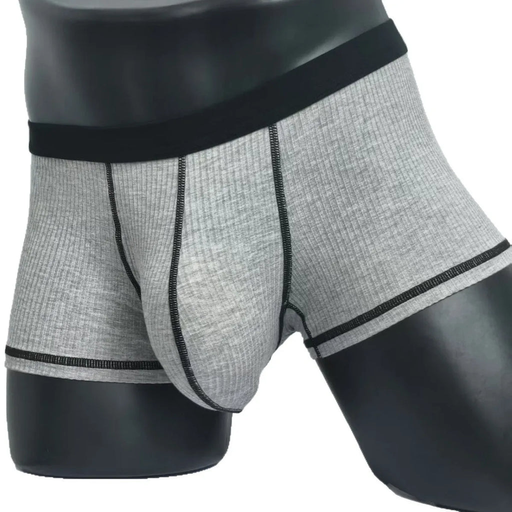 Men's solid colour boxers in breathable fibre fabric on a size chart showing L to 3XL weight ranges.