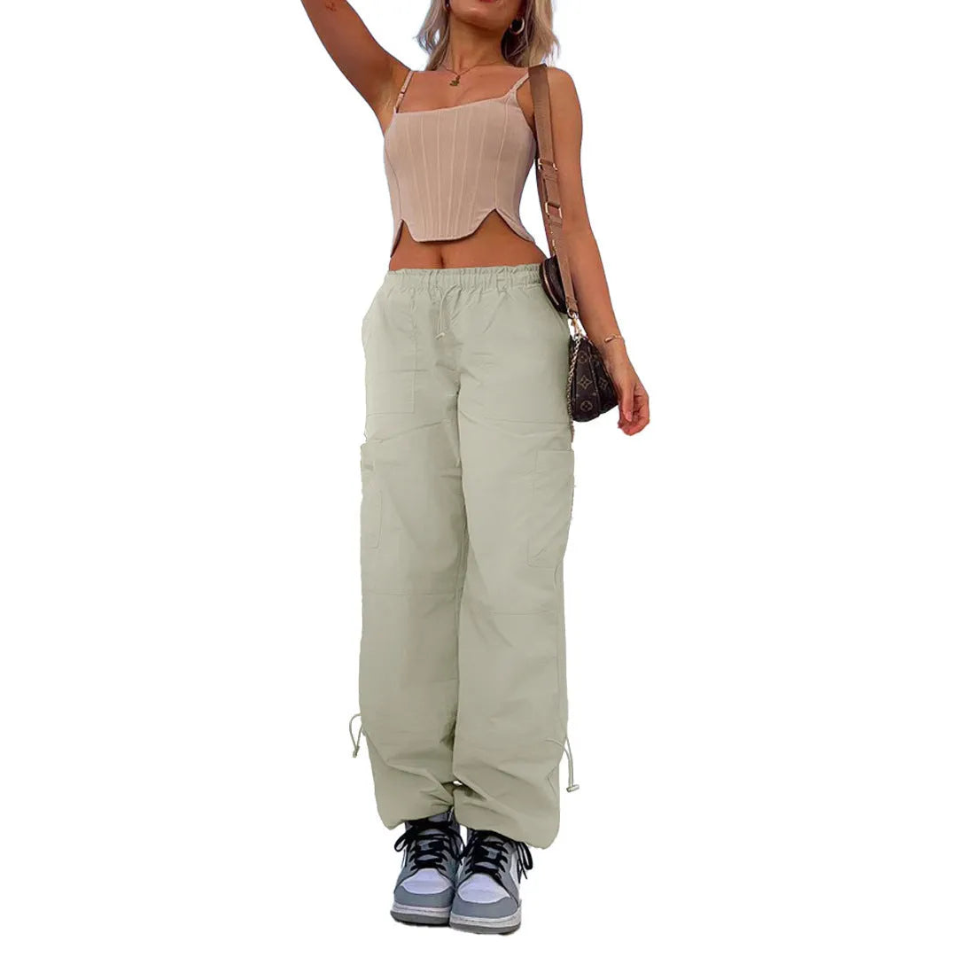 Man wearing loose grey straight-leg cargo casual pants with multiple pockets.