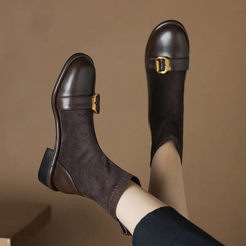Black women's low heel martin boot with lace-up front and belt buckle stitching detail.