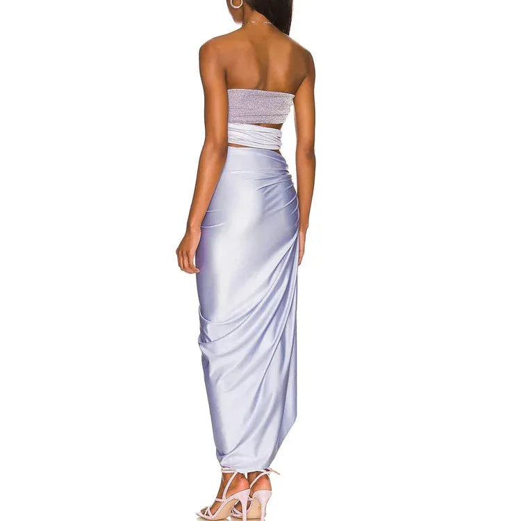 Purple one-piece swimsuit with a separate matching wrap skirt laid flat.