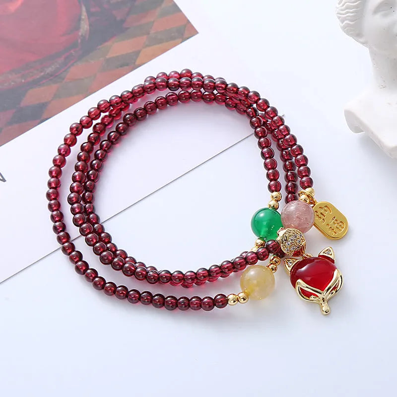 Women's adjustable garnet fox bracelet with rope closure in purplish red colour