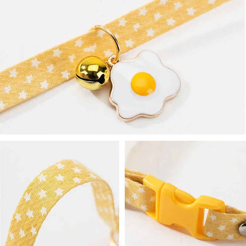 Adjustable green cat collar with a metal bell and a matching bow tie for small pets.