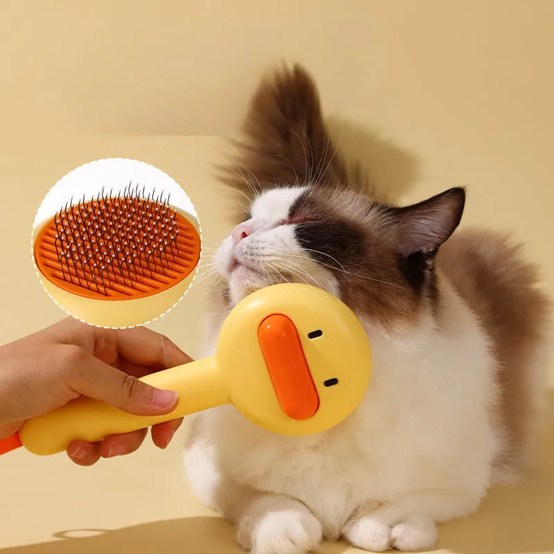 Small yellow plastic duck-shaped pet grooming comb with needle bristles.